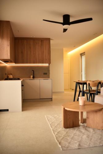 an open kitchen and living room with a table at Słoneczna Polana in Żabiczyn