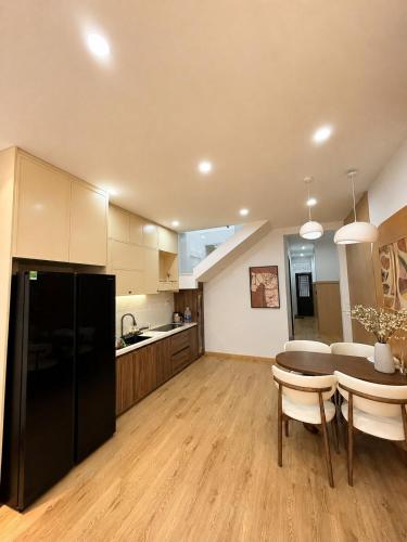 a kitchen with a black refrigerator and a table at Linh's Home in Danang