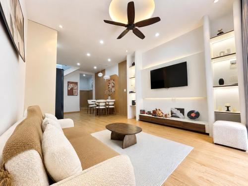 a living room with a couch and a ceiling fan at Linh's Home in Danang