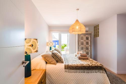 a bedroom with a bed and a window at Los Altos in Almuñécar
