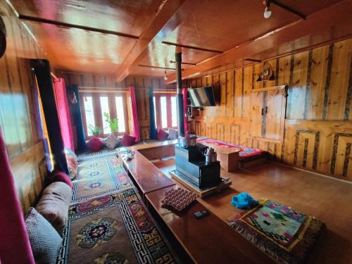 an overhead view of a living room with a couch and a television at Gremuspa Homestay in Kyelang