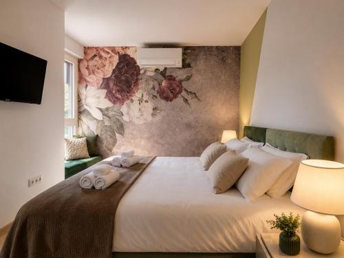 a bedroom with a large bed with towels on it at Visum Residence Labin - Luxury sea view retreat in Labin