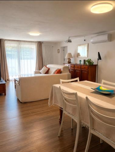 a living room with a couch and a table at I Masselli Home - Appartamento in villa in Trezzano sul Naviglio