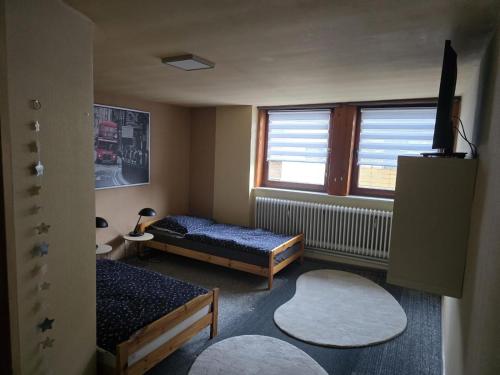a small room with two beds and a window at Apartment Schneider in Höxter