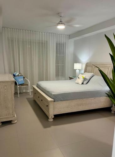a bedroom with a bed and a table and a chair at Ben's Gem in Philipsburg