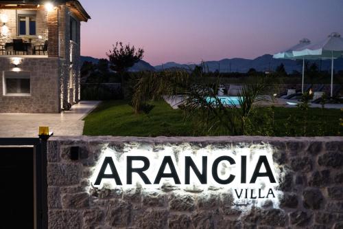 a sign on a wall in front of a house at Villa Arancia in Argos