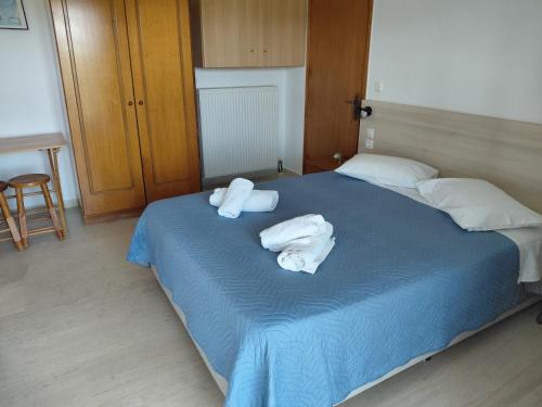 a bedroom with two towels on a bed at Neptune Resort in Kavos