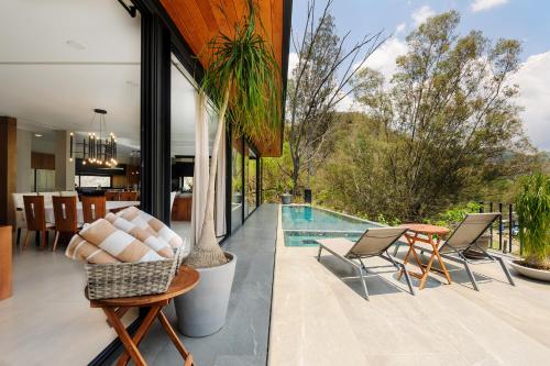 a patio with a table and chairs and a pool at Villa del Carmen in Colorines