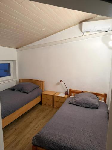 a bedroom with two beds and a lamp in it at Monteurwohnung in Runkel
