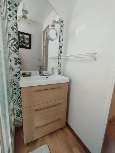 a bathroom with a sink and a mirror at Soucado in Fréjus
