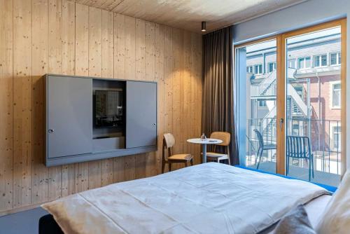 a bedroom with a flat screen tv on a wall at Hotel & Restaurant Heyligenstaedt in Gießen