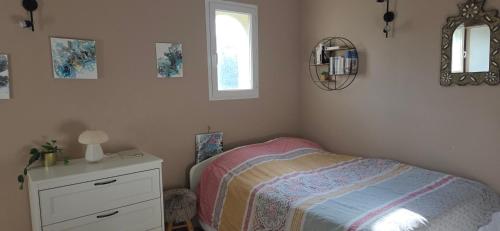 a bedroom with a bed and a dresser and a window at Casa Esperanto in Béziers