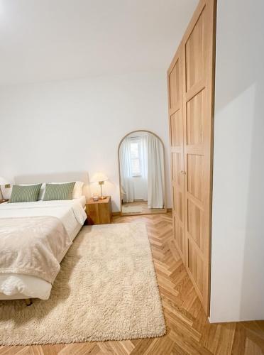 a bedroom with a bed and a large wooden door at Albergo Conca D'Oro in Foggia
