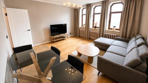a living room with a couch and a table at Greystone Suites & Apartments in Riga