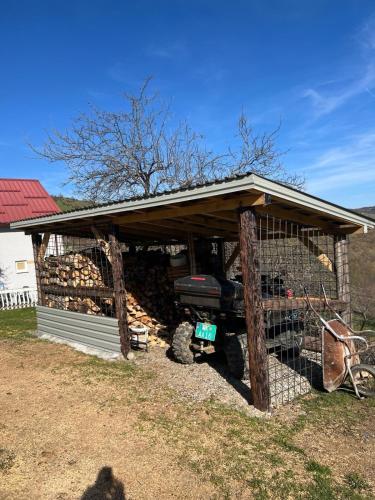 a chicken coop with a truck in it at Rastoder Ponor in Petnjica