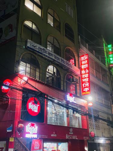 a building with neon signs on the side of it at Hotel Al Fahad in Dhaka