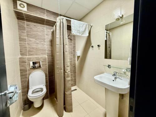 a bathroom with a toilet and a sink at Villa Eleni Apartments Skopje in Skopje