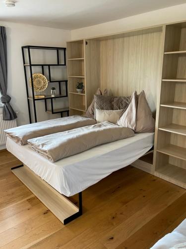 a large bed in a room with shelves at CASA VIVA Panorama Suites in Villach