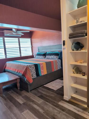 a bedroom with a bed and a closet at Charming 3-Bedroom House Steps from Luquillo Beach in Luquillo