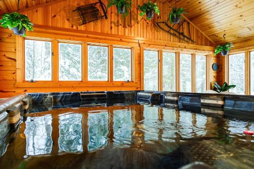 a room with a pool of water in a house at Creekside Chalet - Huge Indoor Spa in Bessemer