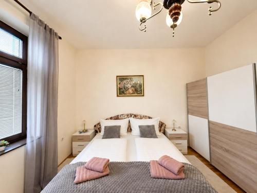 a bedroom with a bed with two pillows on it at Ljubez Apartment in Jajce