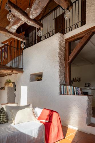 a living room with a couch in a room with wooden ceilings at Casa Yolanda in Bojar