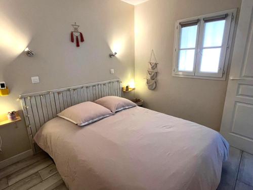 a bedroom with a bed with a cross on the wall at Blue Lagoon in Six-Fours-les-Plages