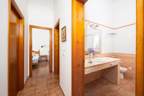 a bathroom with a sink and a toilet at Villa Miguel Dos in Cala en Bosc