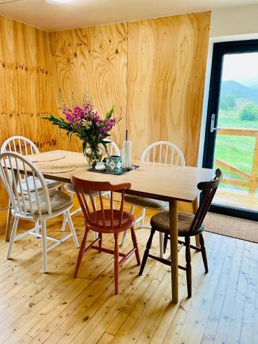 a dining room with a wooden table and chairs at Nykmark - Eco House - Room Selva in Bøstad