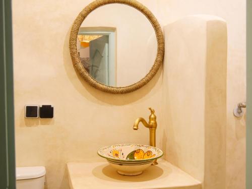 a bathroom with a sink and a mirror at windora essaouira in Essaouira