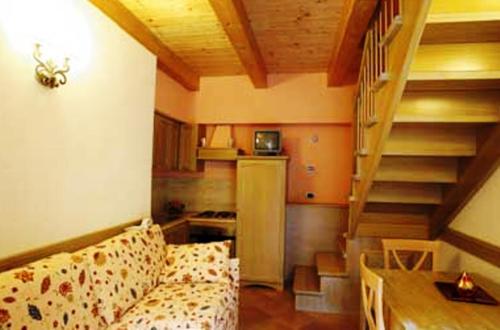 a living room with a couch and a staircase at b&b il postale in Castel di Sangro