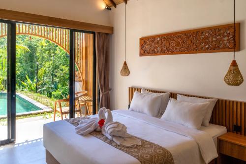 a bedroom with two beds with a stuffed animal on it at Jisa Sidemen in Sidemen