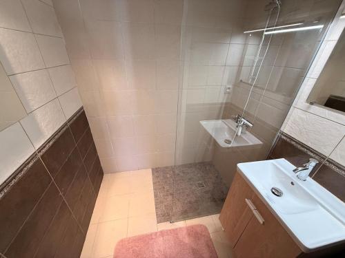 a bathroom with a sink and a toilet and a sink at Le cottage landais in Lit-et-Mixe