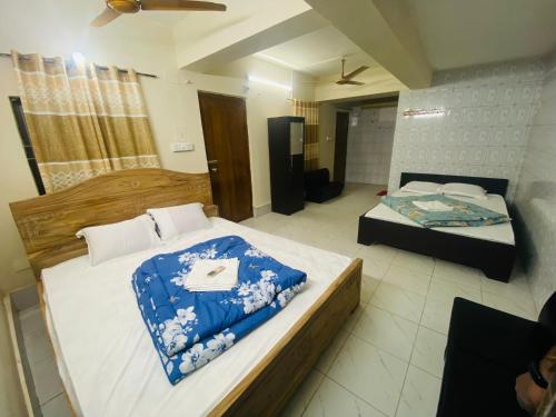 a bedroom with two beds in a room at Hotel Al Fahad in Dhaka