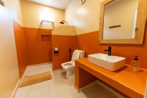 a bathroom with a sink and a toilet at Hostel 197 in Nungwi