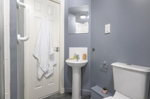 a bathroom with a white toilet and a sink at Sea Point - 2 bed apartment in Saltcoats