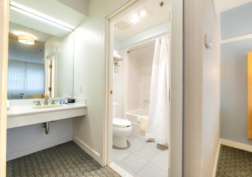 a bathroom with a sink and a toilet and a tub at Two Trees Inn in Ledyard Center