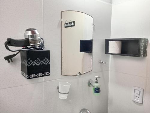 a bathroom with a mirror and a sink at La Casa de Sol in Posadas