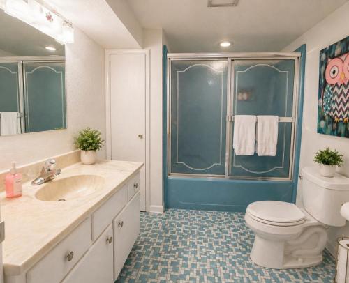 a bathroom with a toilet and a sink and a shower at Backwater Bliss 3BD, 2BA, Grill, Pet Friendly 20PP in Osage Beach