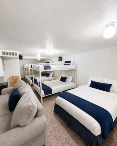 a bedroom with two bunk beds and a couch at Backwater Bliss 3BD, 2BA, Grill, Pet Friendly 20PP in Osage Beach