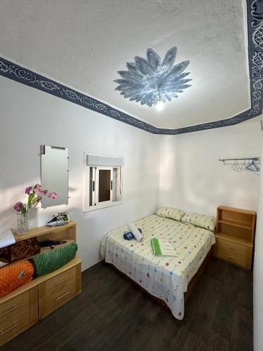 a bedroom with a bed with a flower on the ceiling at Casa Abdel in Larache