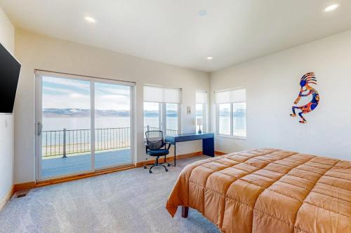 a bedroom with a bed and a desk and a window at Beach Front Haven in Laketown