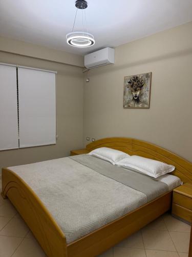 a bedroom with a large wooden bed in a room at Seaside Family Escape in Golem