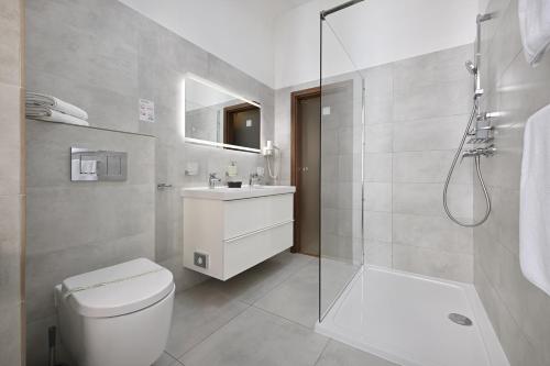 a bathroom with a toilet and a sink and a shower at U Schnellu in Prague