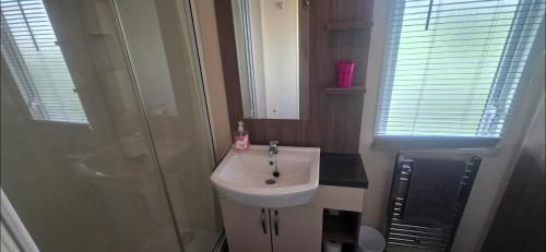 a small bathroom with a sink and a shower at LJ Holiday Let in Middleton