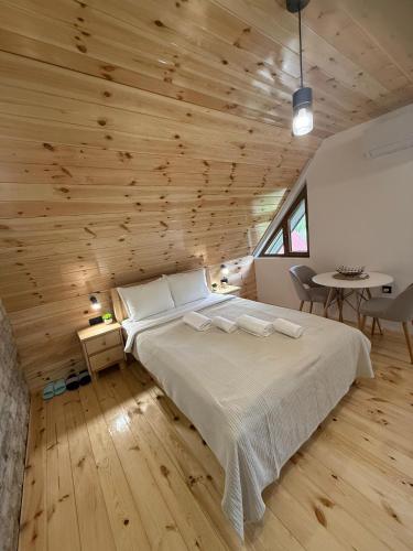 a bedroom with a bed and a wooden ceiling at Apartments S&S in Žabljak