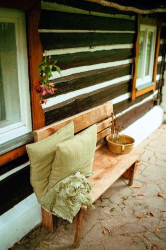 a bench sitting on the side of a building at Zenovna - Roubená chaloupka in Krásná