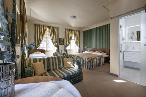 a hotel room with a couch and a bed at U Schnellu in Prague