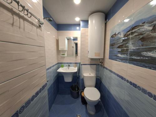 a bathroom with a toilet and a sink at Harmonia in Ruse