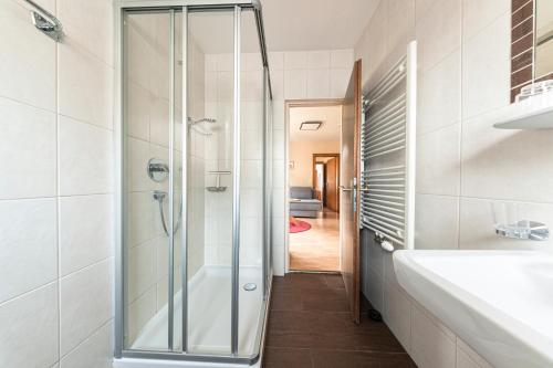 a bathroom with a shower and a sink at Beim Franz in Lermoos
